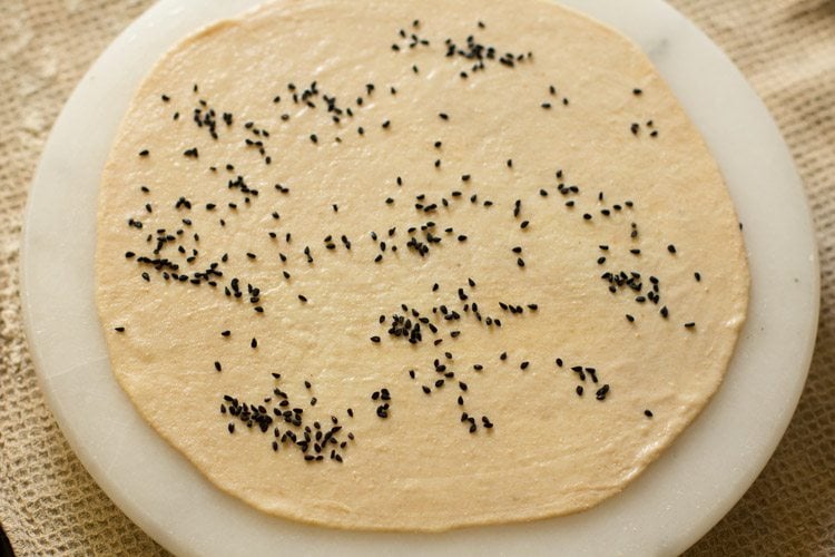 nigella seeds sprinkled all over the rolled disc or naan. 