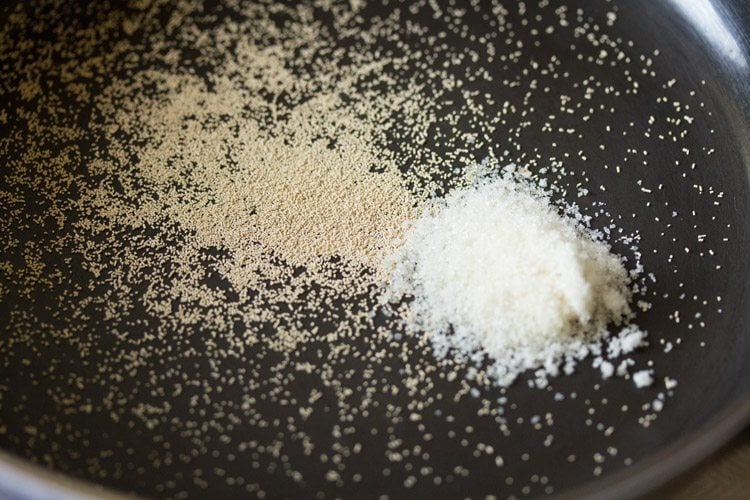 instant yeast and sugar added in a mixing bowl. 