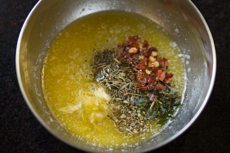 dried oregano, dried thyme, dried basil, red chili flakes and black pepper powder added to the melted butter. 