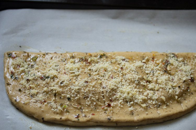 grated parmesan cheese sprinkled on top of the bread. 