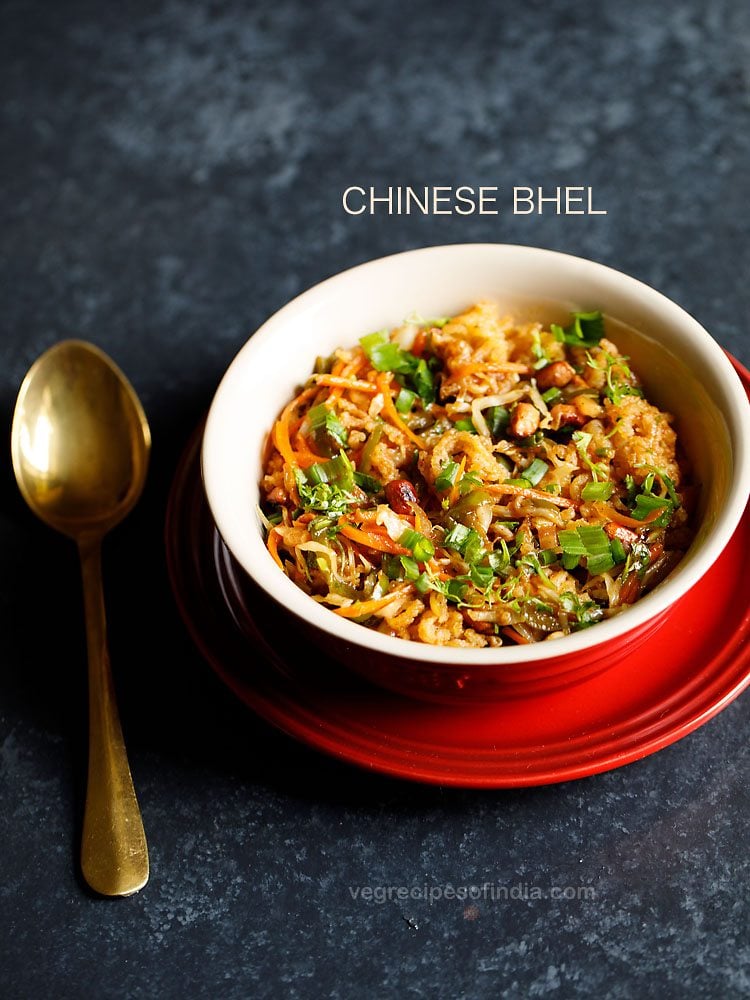 chinese bhel served in a red ceramic bowl placed on a red plate with a spoon kept on the left side and text layover.