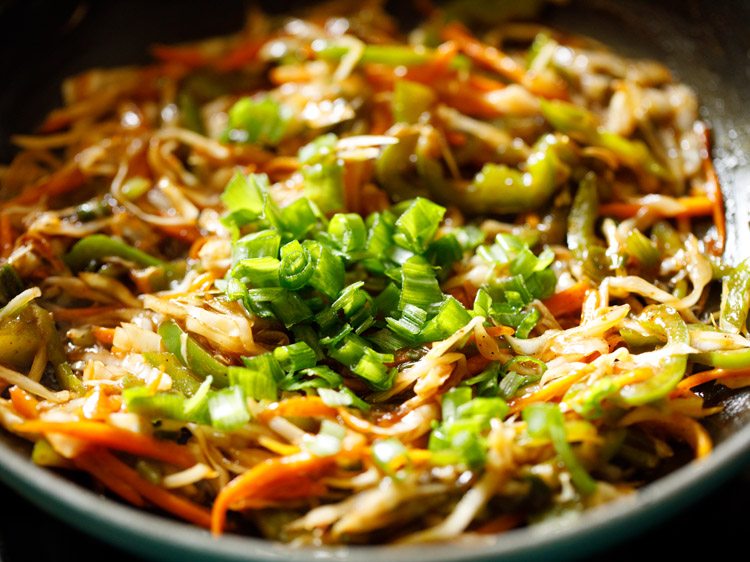 chopped spring onion greens added to cooked vegetables. 