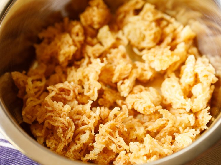 broken fried noodles added in a bowl. 