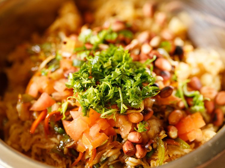 chopped coriander leaves and chopped spring onion greens added to bowl. 