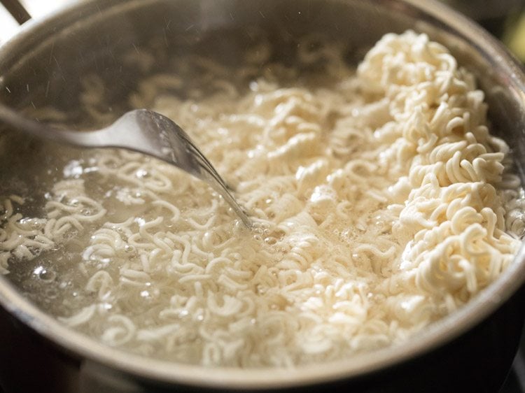pressing noodles in boiling water. 