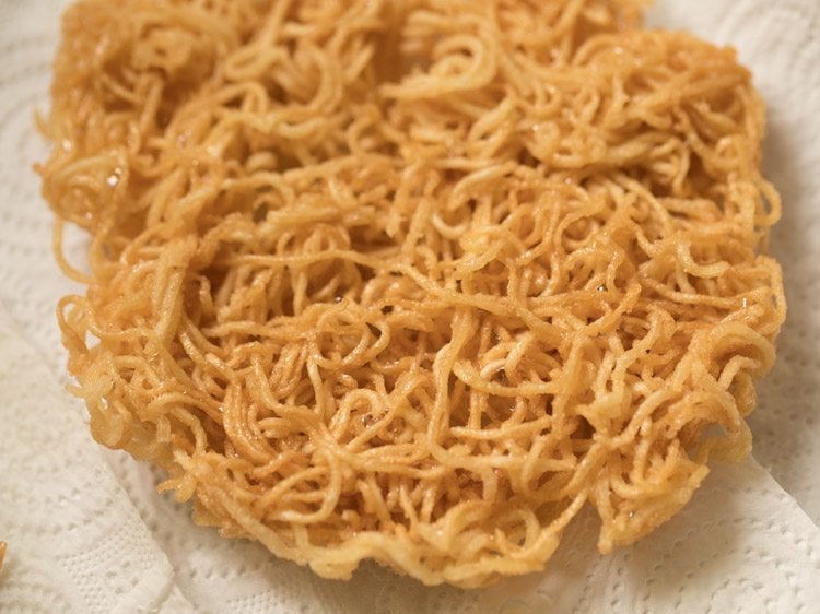 fried noodles placed on kitchen paper towel. 