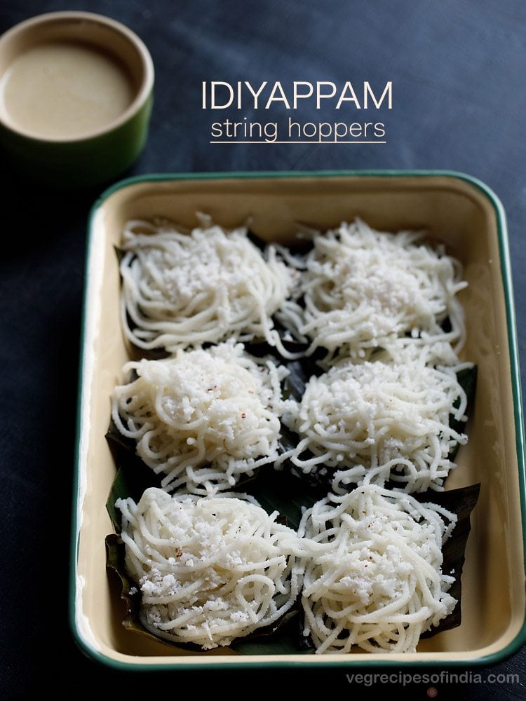 idiyappam sprinkled with grated coconut and placed on banana leaves on a tray with a bowl of coconut chutney kept on the top left side and text layovers.