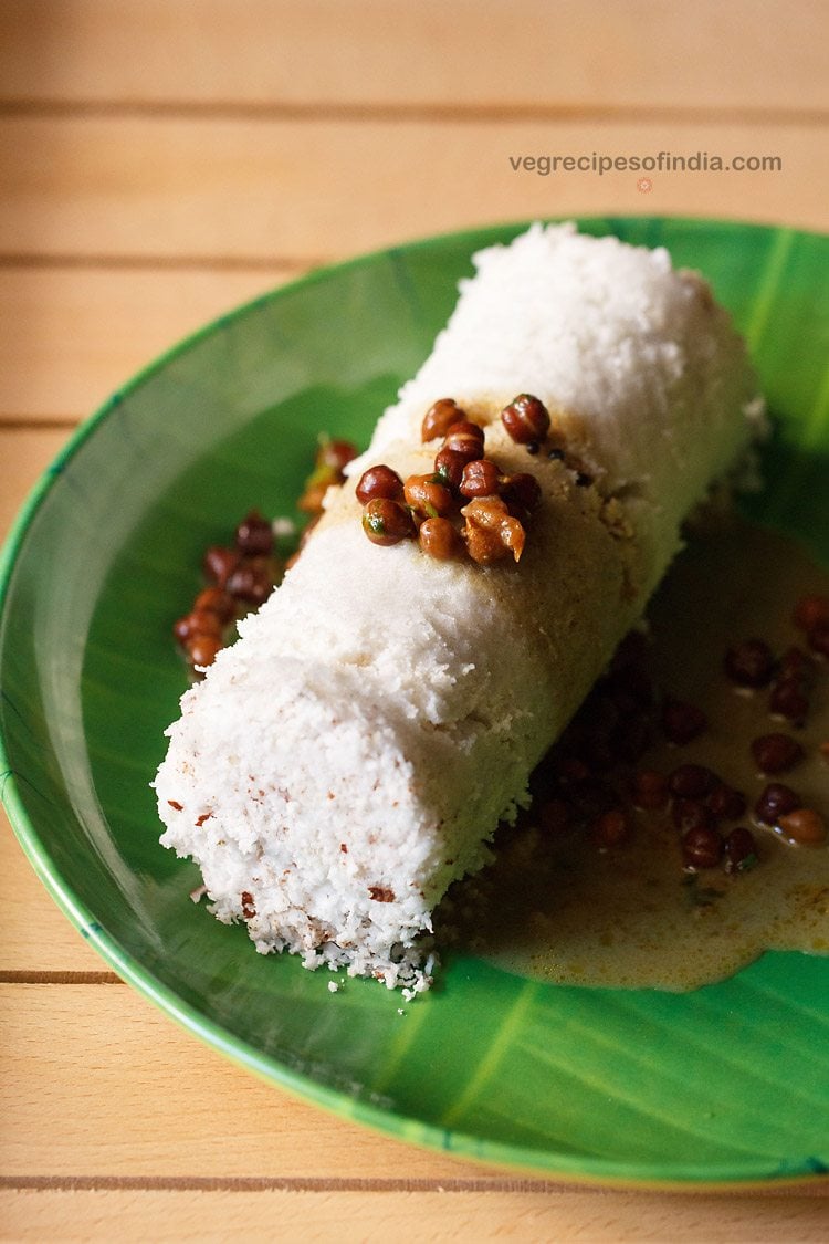 puttu served on a green colored plate with black chickpea curry on it and text layover.