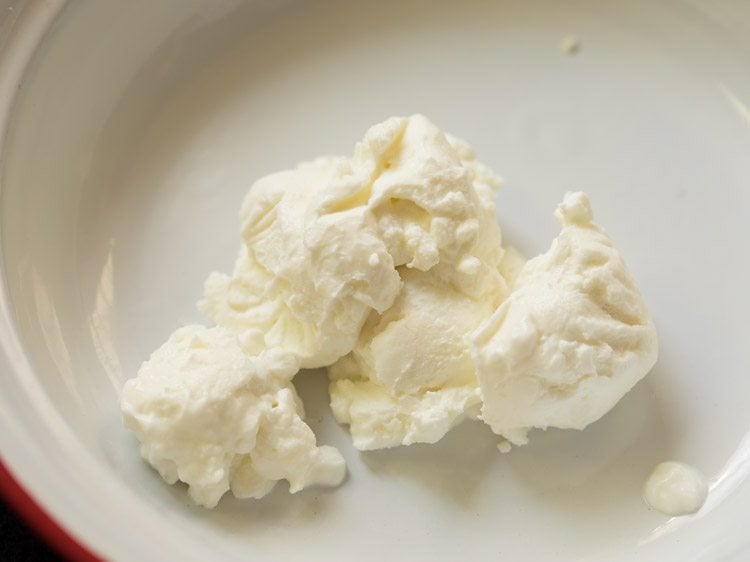 hung curd added to a bowl for making the marinade. 