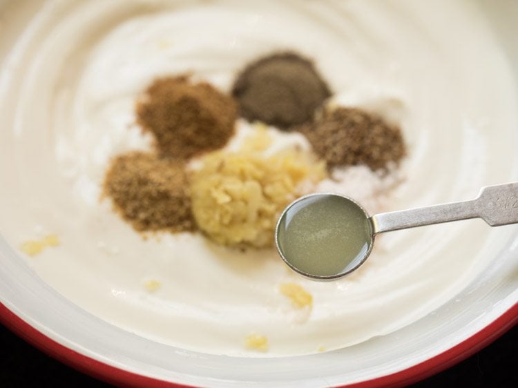 adding lemon juice to the hung curd-cream mixture. 