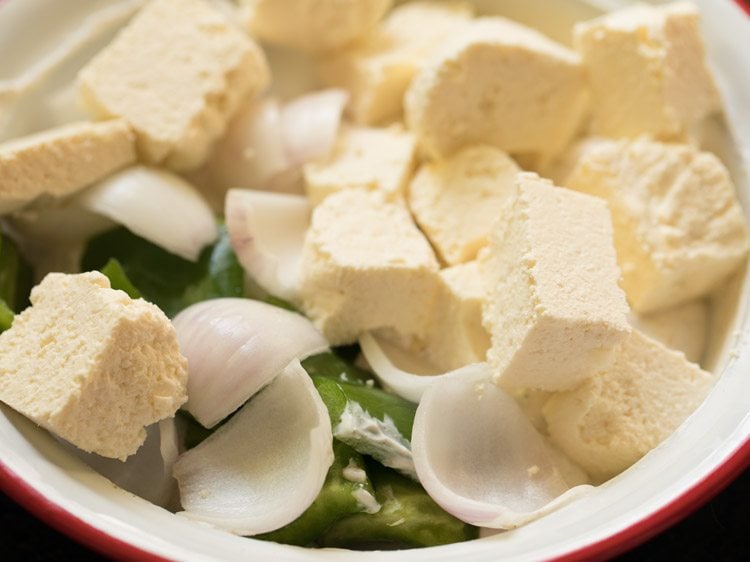 paneer cubes, onion squares and capsicum squares added to the marinade. 