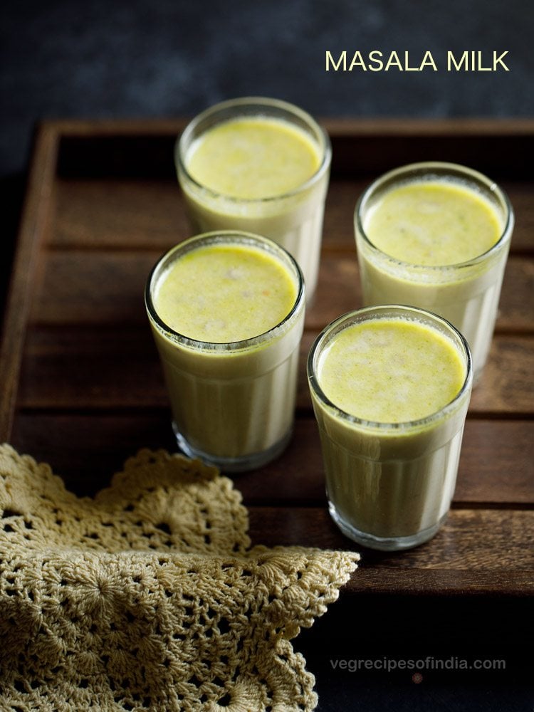 masala milk served in 4 glasses with text layovers.