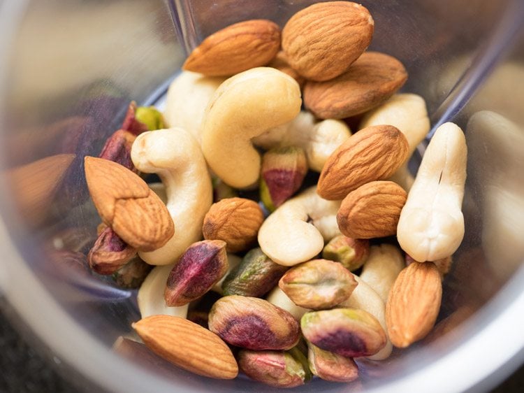 almonds, cashews and pistachios added in a grinder jar. 