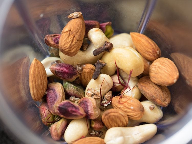 saffron strands, cardamom seeds and cloves added to the grinder jar. 