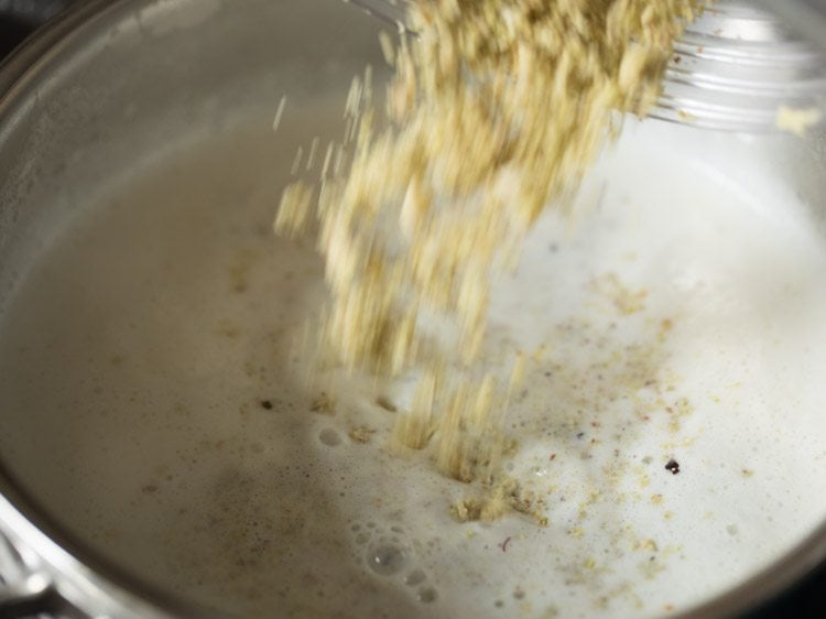 adding prepared nuts and spices powder to the hot milk. 