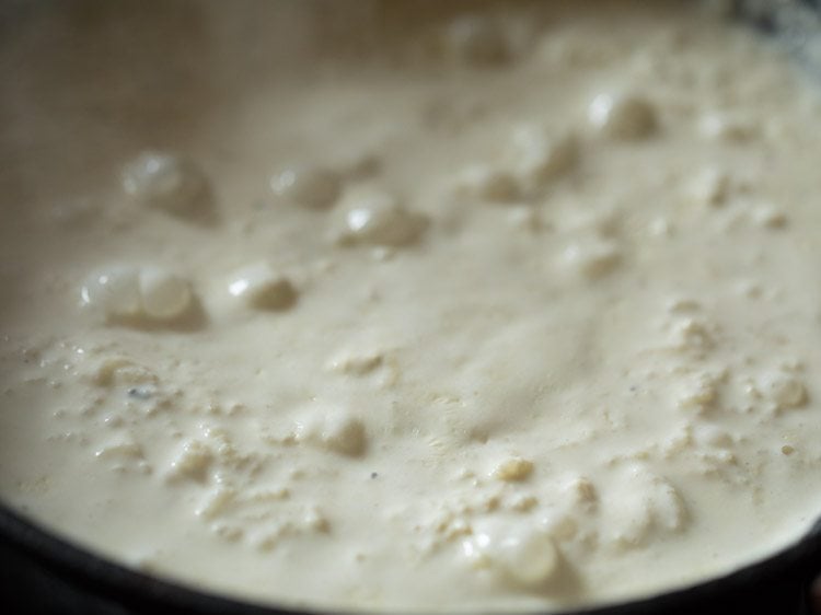 rice getting cooked and milk thickening and reducing. 