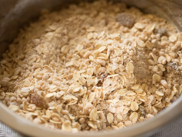 oats and raisins have been mixed in and the dough is quite dry and rough.