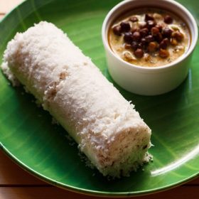 puttu served on a green colored plate with a bowl of black chickpea curry kept on the side.