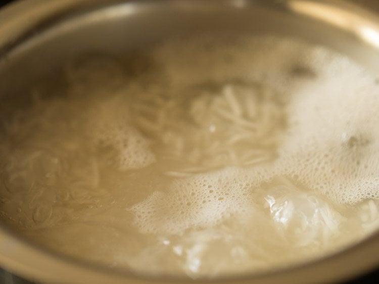 Water and rice cooking in a pan.