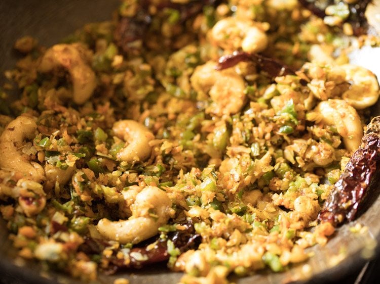 Kashmiri red chili powder, black pepper powder, coriander powder, and garam masala powder added mixed with the stir fry.