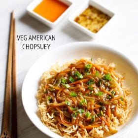 american chop suey served in a white bowl with chopsticks and sauces kept on the side and text layovers.