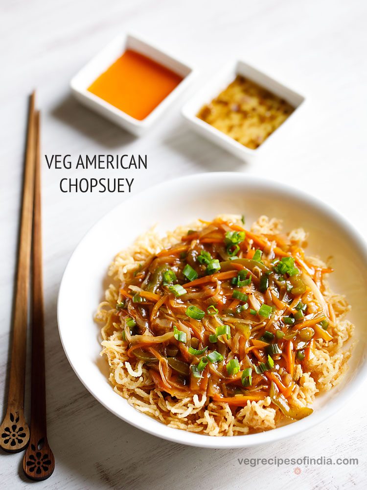 american chop suey served in a white bowl with chopsticks and sauces kept on the side and text layovers.