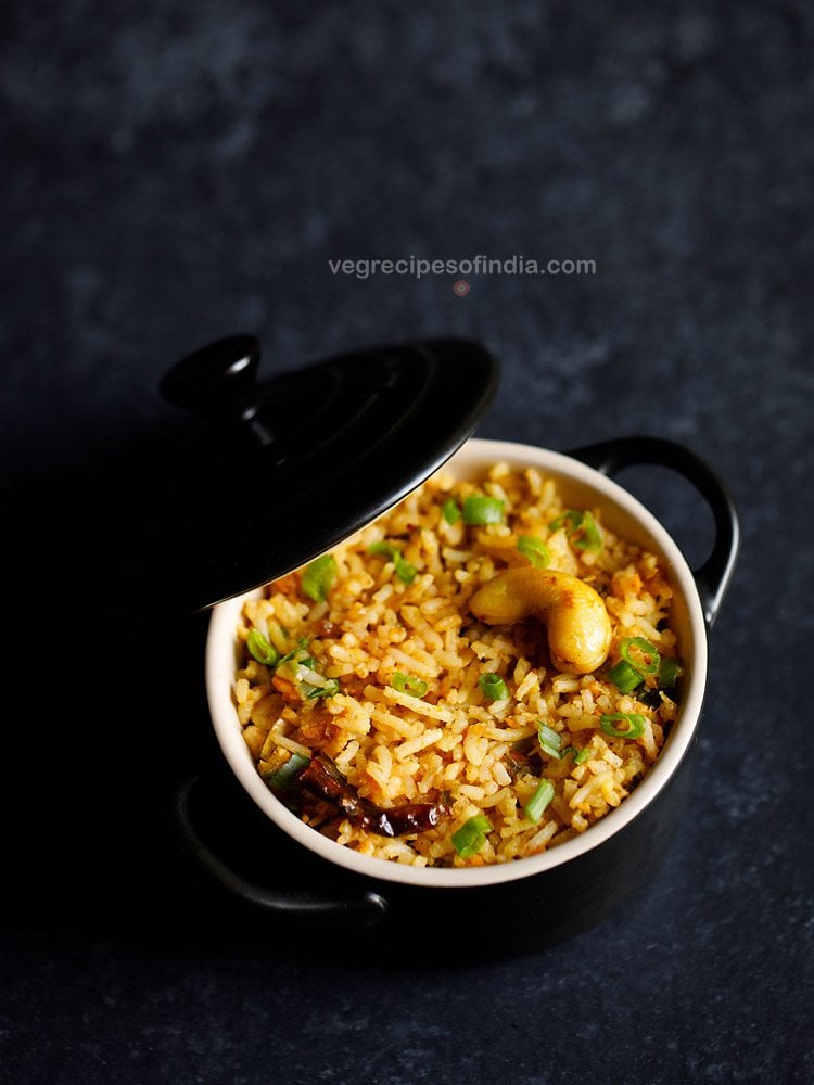 Singapore fried rice served in a small black pan.