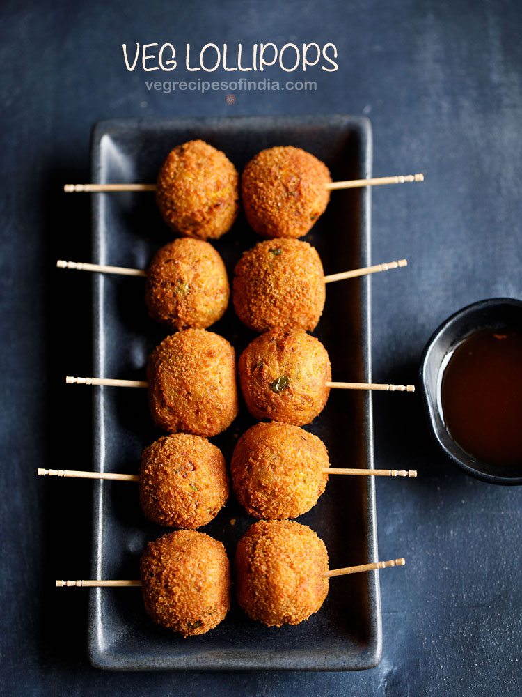 veg lollipop served on a black platter with a small bowl of tomato ketchup kept on the right side and text layover.