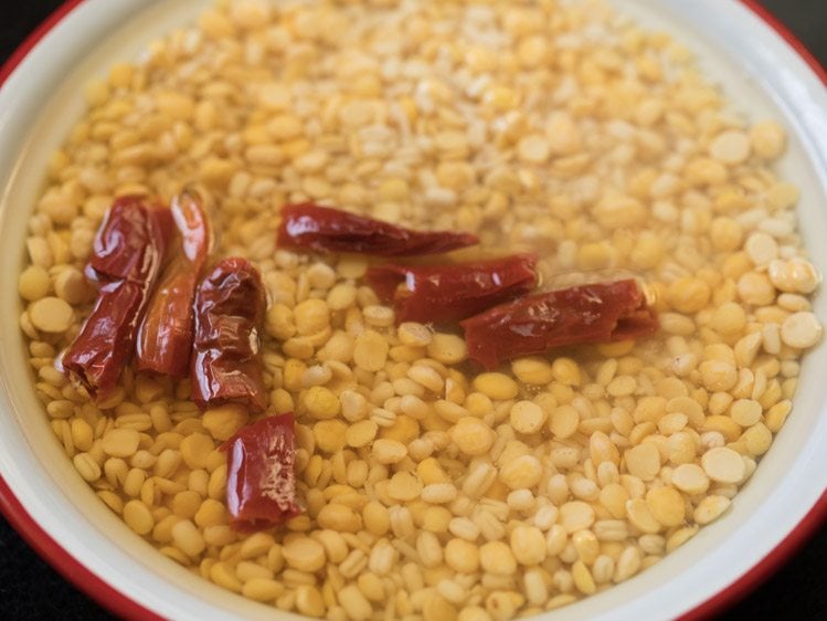 soaking rice, chana dal, urad dal, tuvar dal and dried red chilies for making batter for adai dosa. 