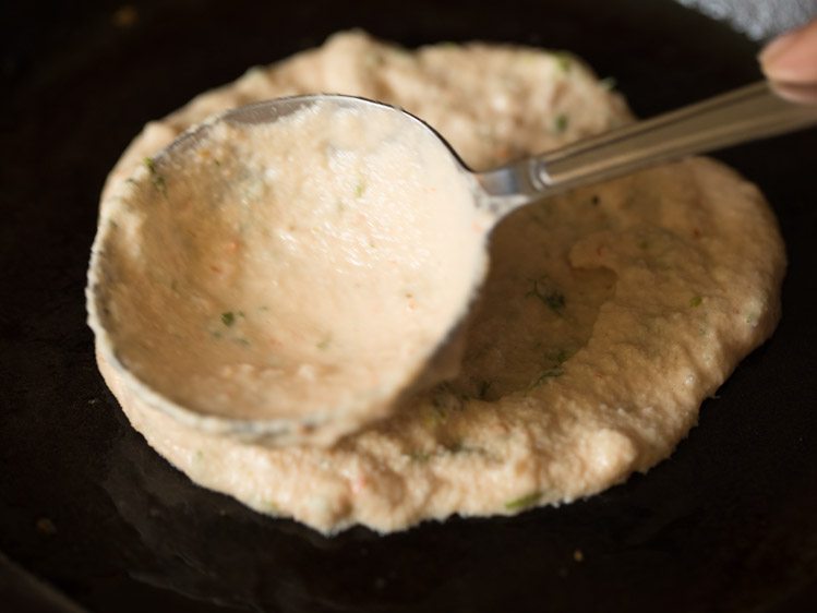 spreading batter to a circle for adai recipe. 