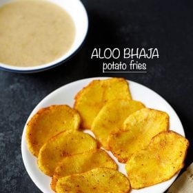 The aloo bhaja is served on a white plate with the word stay on it.