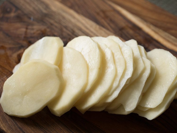 peeled and thickly sliced potatoes. 