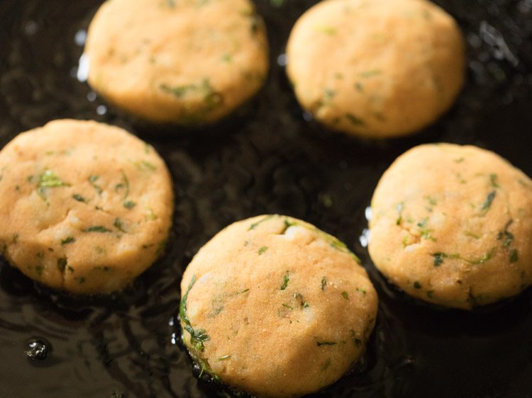 frying aloo tikkis. 