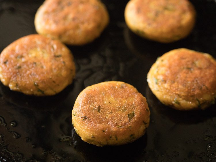 frying aloo tikkis till evenly golden from both sides. 