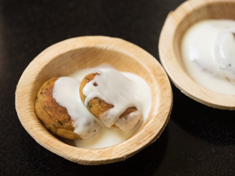 aloo tikkis topped with some whisked curd. 