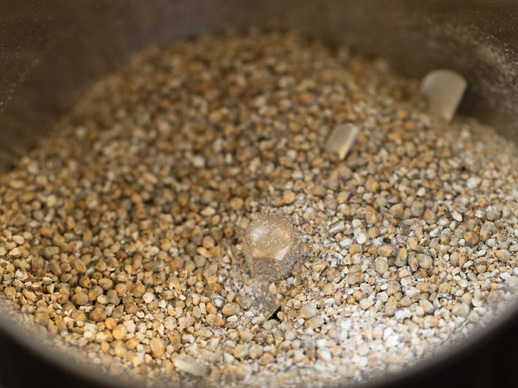 coarsely ground bajra in grinder jar.