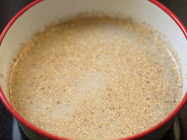 soaking coarsely ground bajra to make bajra khichdi recipe.