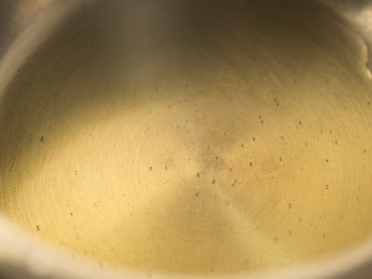 oil in the bottom of a pressure cooker.