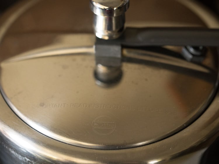 lid is placed back on the pressure cooker.