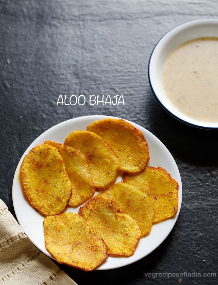 aloo bhaja served on a white plate with text layovers.