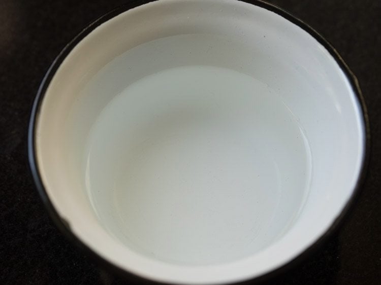 pour the warm water into a medium bowl.