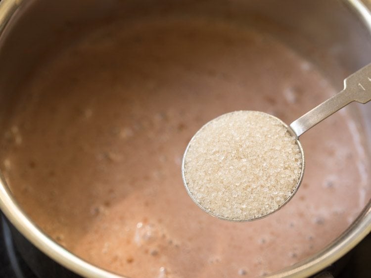 adding sugar to cocoa powder mixture