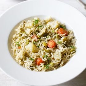 brinji rice served in a white plate.