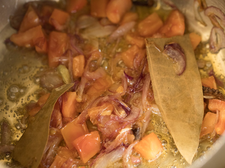 sautéing tomatoes with onions. 