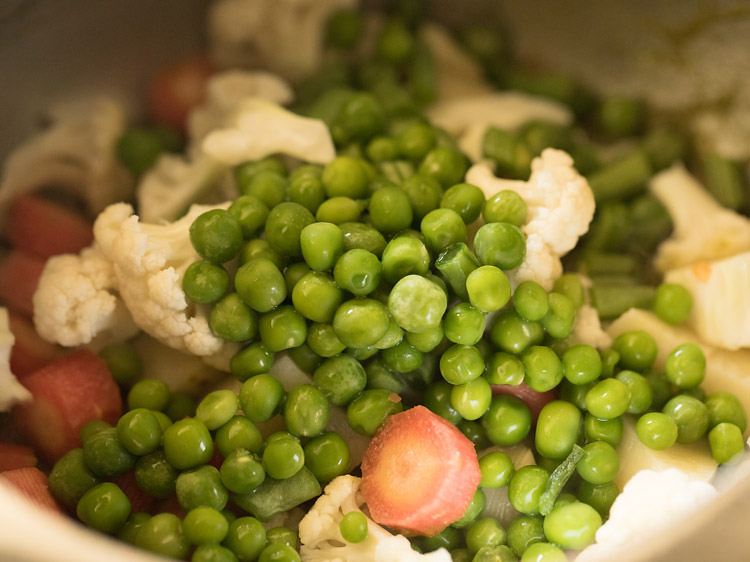 vegetables added to the pressure cooker. 