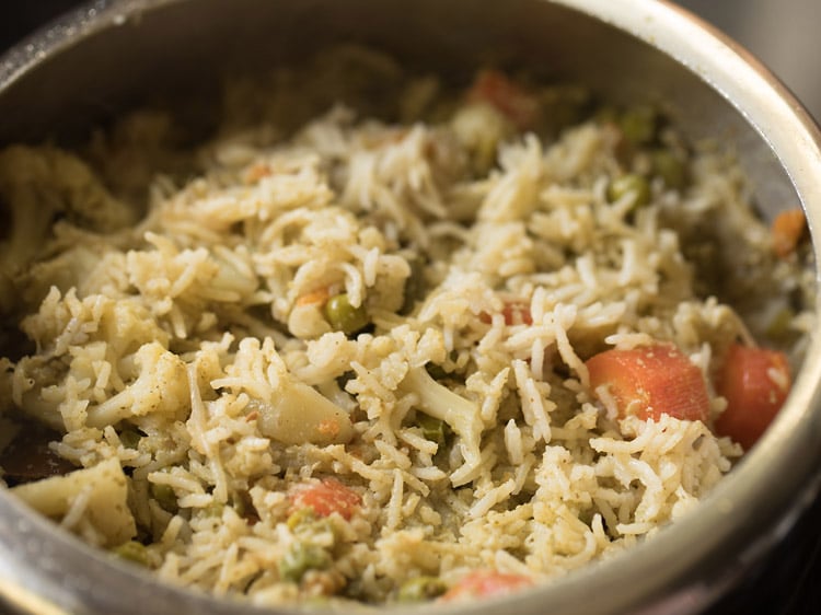 mixing the rice with the coconut milk layer gently. 