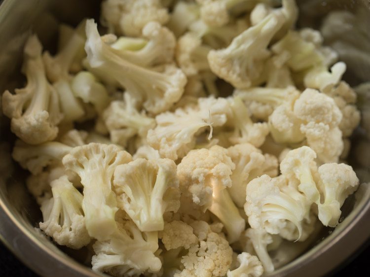 close up shot of cauliflower florets in mixing bowl