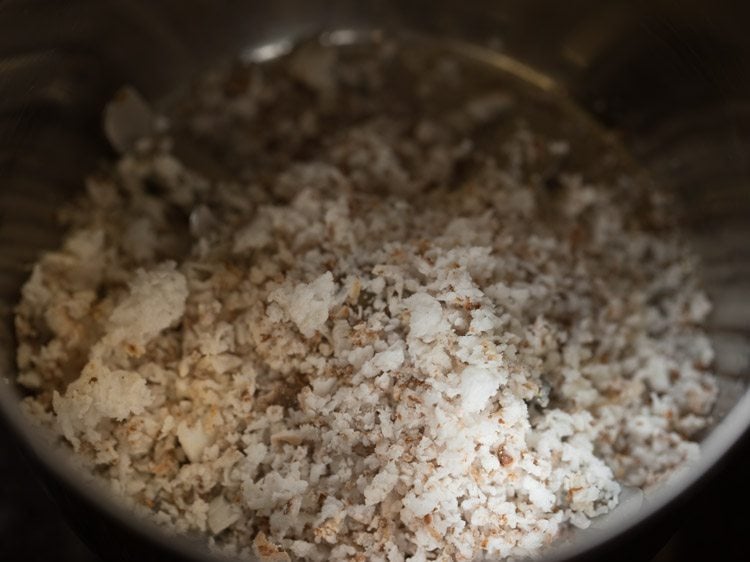 close up shot of grated coconut in mixing bowl