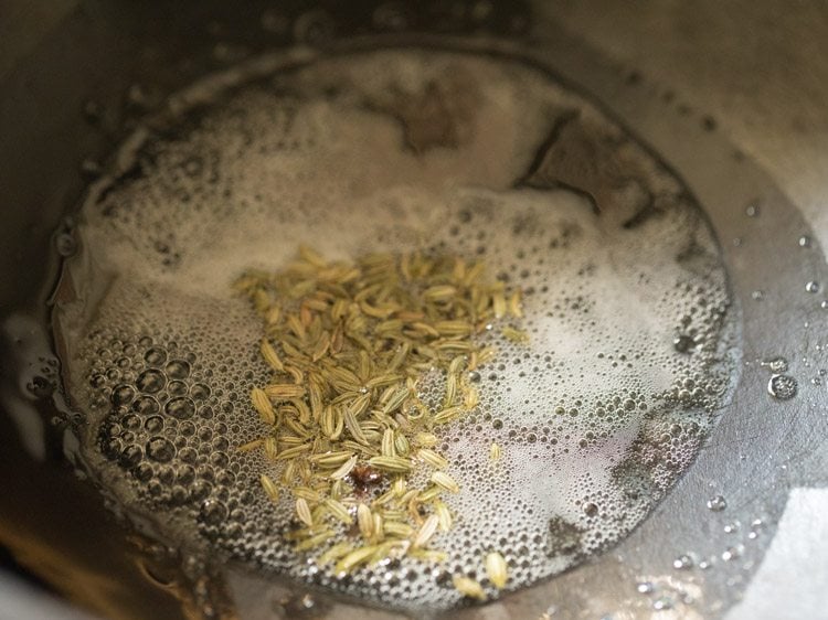 top shot of oil and seeds heating in saucepan