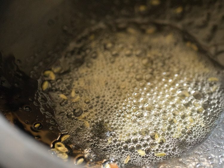 top shot of oil and seeds cooking in saucepan